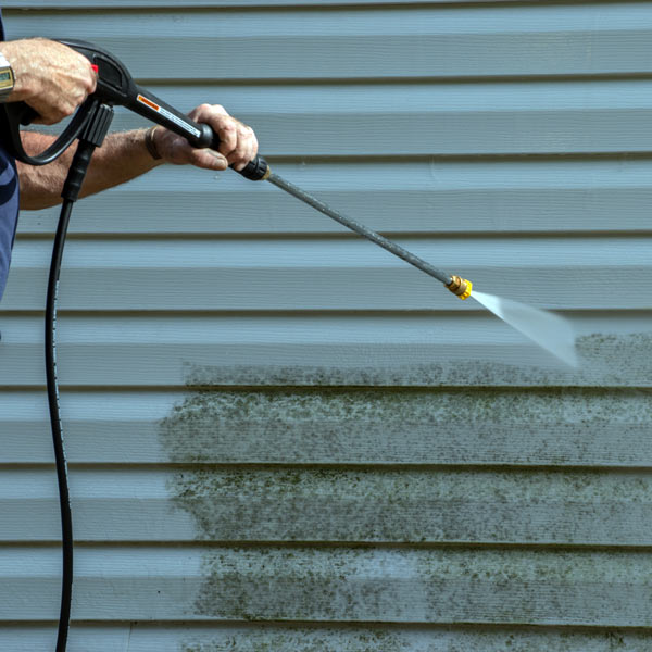 house siding being pressure washed